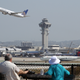 People watch as a United Airlines jet passes the air traffic control tower at Los Angeles International Airport during take-off on April 22, 2013.
David McNew/Getty Images